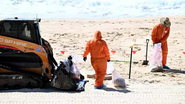 Beaches reopen after baffling tar ball mystery