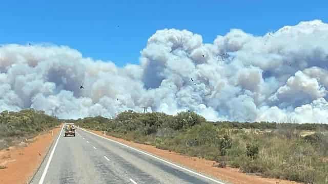 'Not out of the woods yet': bushfire triples in size