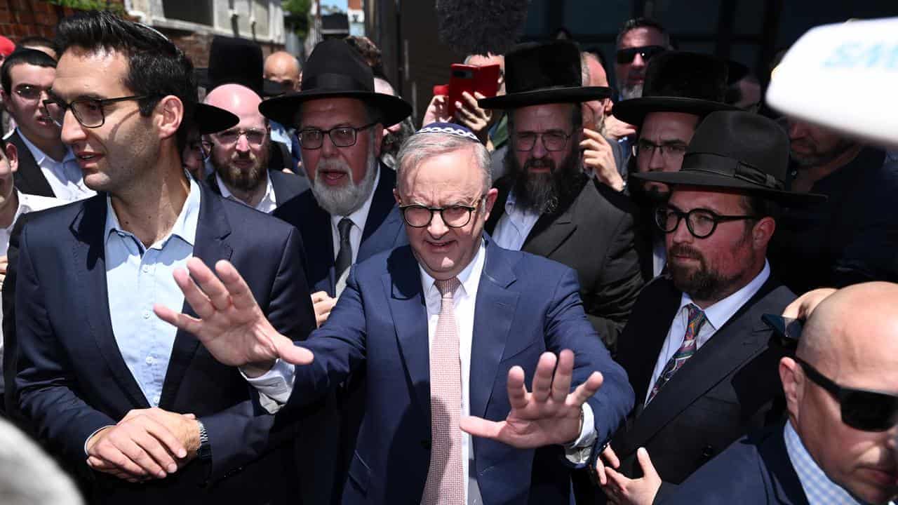 'Cheap and late': PM heckled at firebombed synagogue