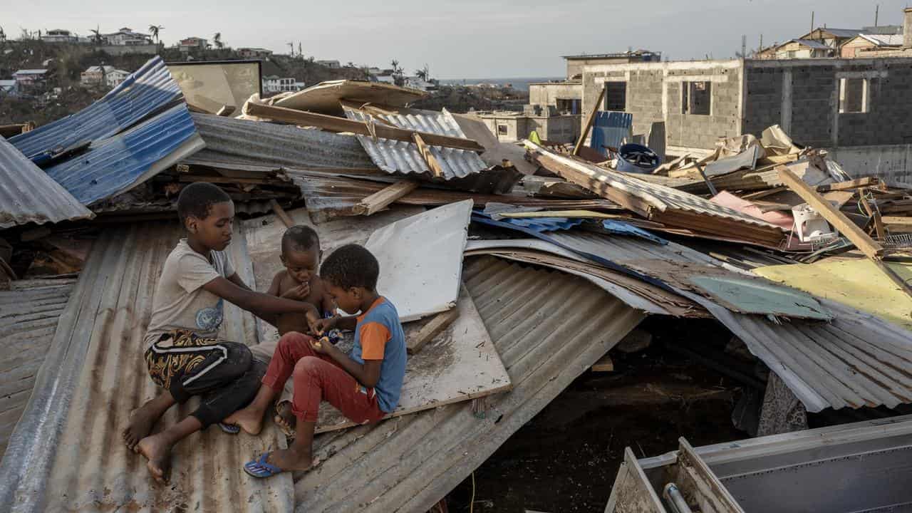 Macron swears in angry exchange in cyclone-hit Mayotte