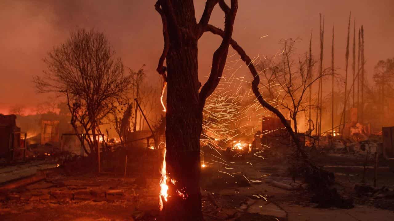 LA firefighters make progress as winds ease, 11 dead