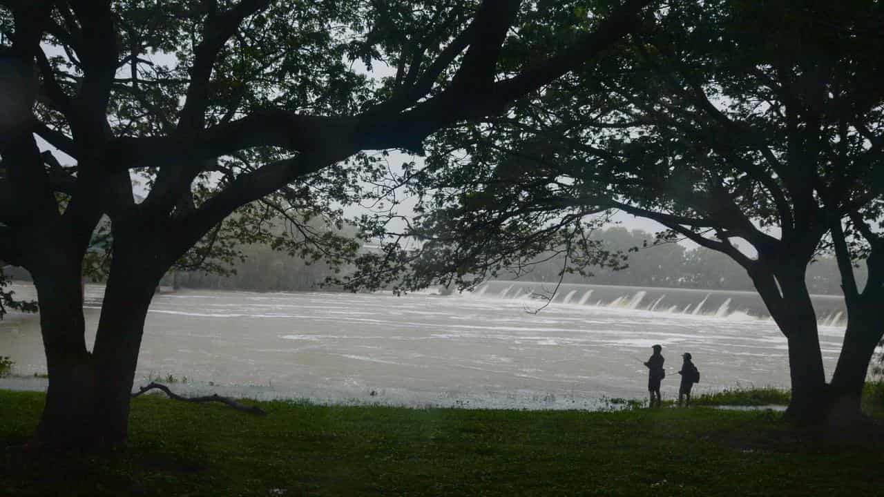 One dead as floodwaters rage with more rain on the way