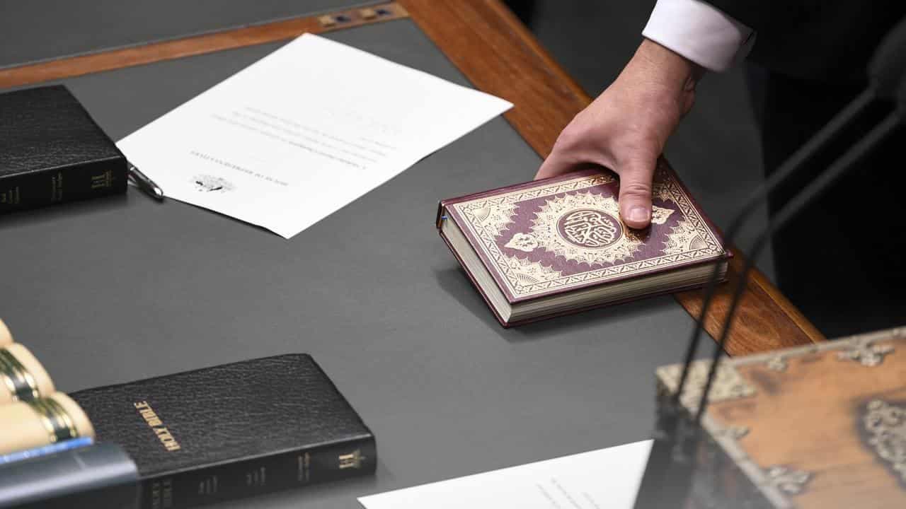 Constitution doesn't prevent MPs being sworn in holding Koran