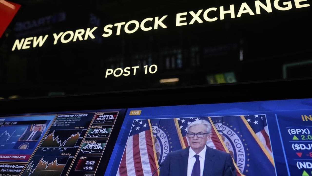 Wall Street lower as investors weigh Powell comments