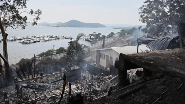 Dozen homes destroyed in town by fast-moving bushfire