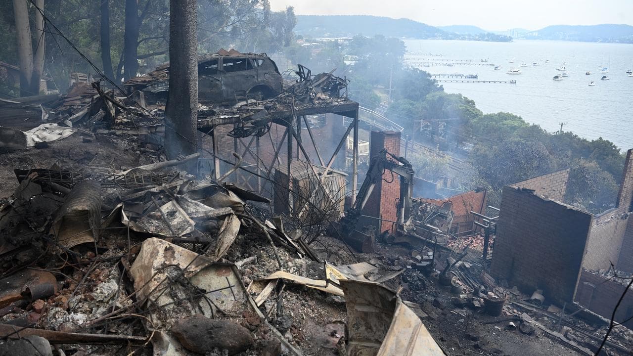 Wind change heightens fire risk as a dozen homes lost