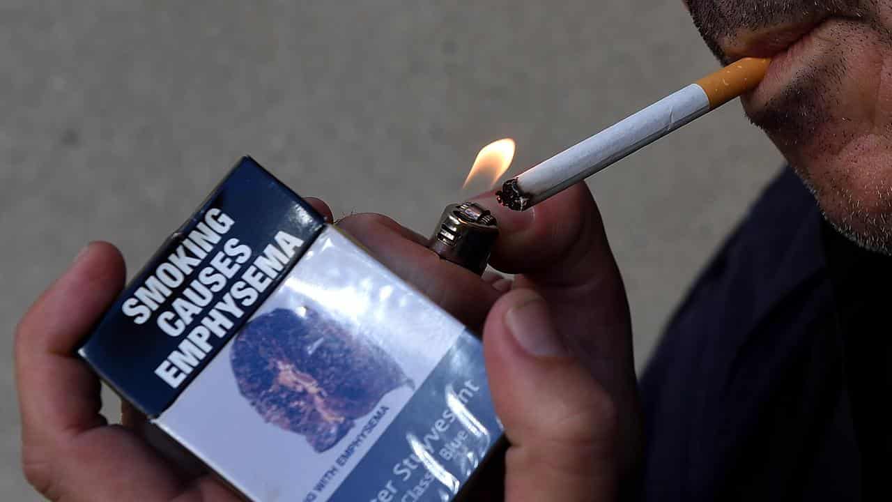 Bold cigarette warnings on table to stub out smoking