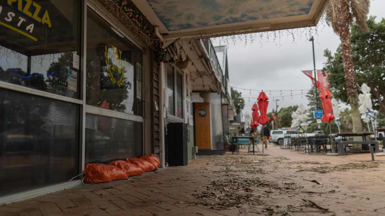 Floods, cyclone put New Zealand in slender recession