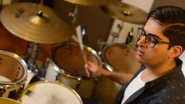 Refugee drummer beats a path to healing for students