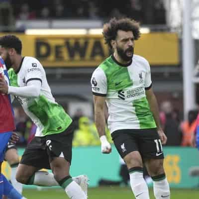 Salah's 200th goal sends 'lucky' Liverpool top of EPL