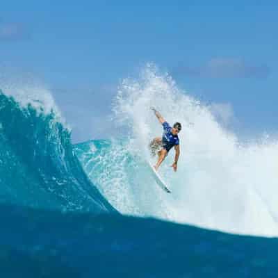 Three Aussie men charge into Sunset Pro surf quarters