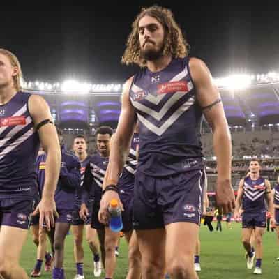 Swans crush mourning Dockers on day of sadness