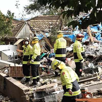 Race to free woman trapped beneath collapsed townhouse