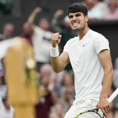 Alcaraz overcomes scare to down pal Tiafoe at Wimbledon