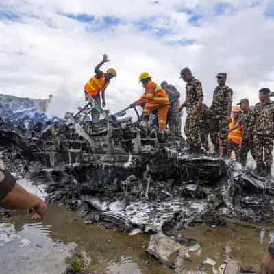 Plane slips off runway at Nepal airport, killing 18