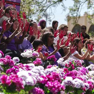 Raised hands in Red Centre as survivors call for change