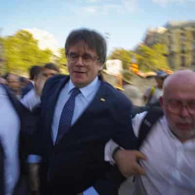 Catalan leader gives police the slip on return to Spain