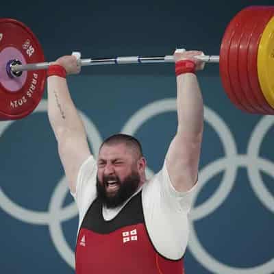 Strongman Talakhadze three-peats as weightlifting champ