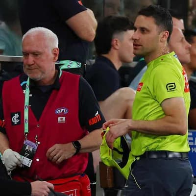 AFL fan banned for life after umpire hit with bottle