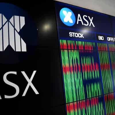 ASX slips but still closes just under record high