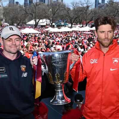 Lions fans roar as Swans fly high at grand final parade