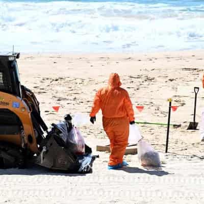 Beaches reopen after baffling tar ball mystery