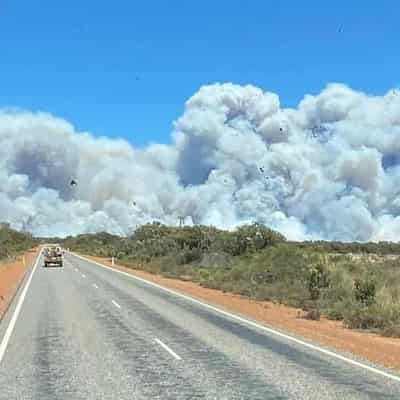 'Not out of the woods yet': bushfire triples in size