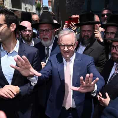 'Cheap and late': PM heckled at firebombed synagogue