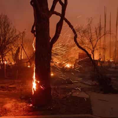 LA firefighters make progress as winds ease, 11 dead