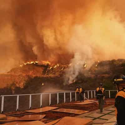 Aerial fight to stop LA wildfires as death toll rises