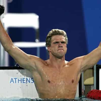 Replica Olympic medals given to fire-hit US swim great