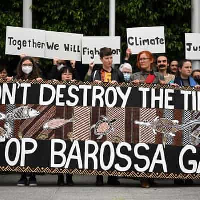 Santos cuts dividend, says Barossa project nearly done