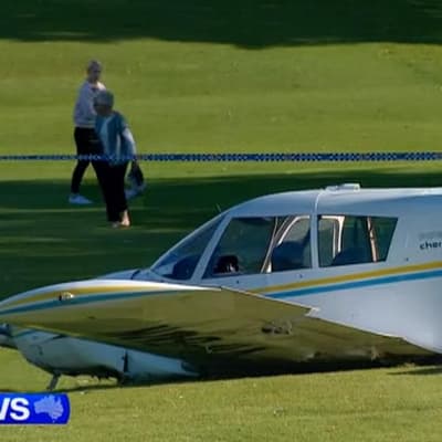 Light plane crash lands on suburban golf course