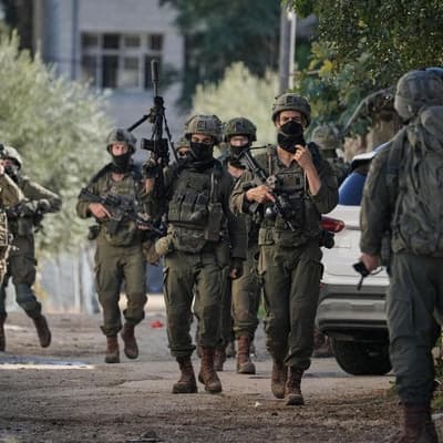 Pair shot after appearing to surrender in West Bank