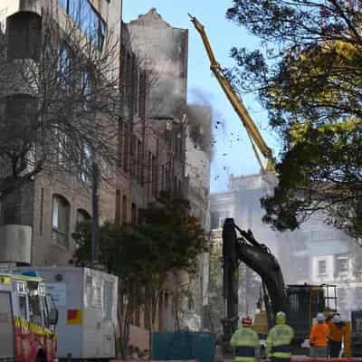 Body search delayed by demolition of city fire building