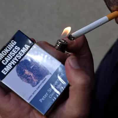 Bold cigarette warnings on table to stub out smoking