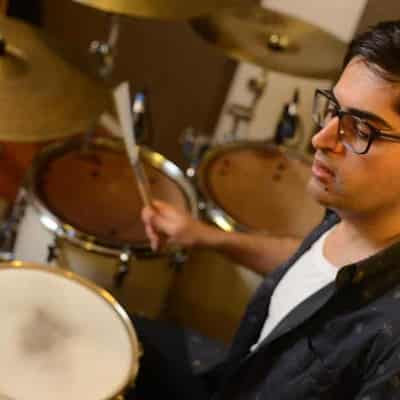 Refugee drummer beats a path to healing for students