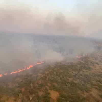 Fire too fast for containment lines near NT town