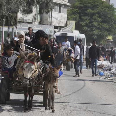 Civilians flee Gaza City as Israel masses tanks, troops