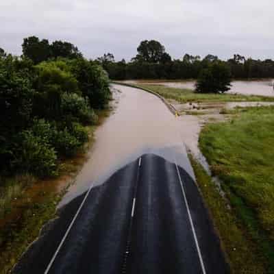 Floods and outages hit two states as deluge persists